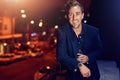 Friday night in the city. Portrait of a happy young man posing alone on the balcony of a nightclub. Royalty Free Stock Photo