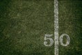 Friday Night Lights Football Game on Football field fifty yard line background Royalty Free Stock Photo