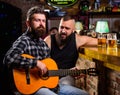 Friday relaxation in bar. Friends relaxing in bar or pub. Real men leisure. Hipster brutal bearded spend leisure with Royalty Free Stock Photo