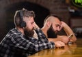 Friday relaxation in bar. Hipster bearded man spend leisure at bar counter. Order drinks at bar counter. Men with Royalty Free Stock Photo