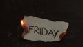 Friday word written on white paper burns. Fire with smoke and ashes on black background Royalty Free Stock Photo