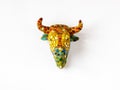 Fridge magnet souvenir in shape of one decorated brown bull head in Gaudi style isolated on white background Royalty Free Stock Photo