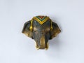 Fridge magnet souvenir in shape of one decorated brown elephant head on white background. Royalty Free Stock Photo