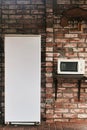 Fridge and microwave in the courtyard of a brick house