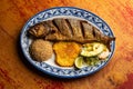 Fried anchovy served with patacon, coconut rice and vegetable salad Royalty Free Stock Photo