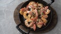 Fried appetizing shrimp in a cast iron skillet