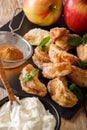 Fried apples with cinnamon close-up with cream and mint. Vertical Royalty Free Stock Photo