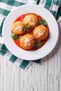 Fried arancini rice balls with tomato sauce. vertical top view