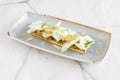 Fried artichoke toast with plenty of parmesan cheese flakes, coriander and garlic confit on a gray plate Royalty Free Stock Photo