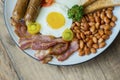 Fried bacon with beans and sausage on the plate Royalty Free Stock Photo