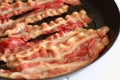 Fried bacon in a pan for breakfast Royalty Free Stock Photo