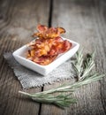 Fried bacon strips with fresh rosemary Royalty Free Stock Photo