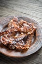 Fried bacon strips on the plate Royalty Free Stock Photo