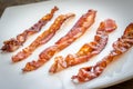 Fried bacon strips on the square plate Royalty Free Stock Photo