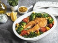 Fried baked fish steak salmon, trout with broccoli and carrots, corn in pot Royalty Free Stock Photo