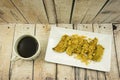 Fried Banana (Pisang Goreng), traditional snack in Malaysia with black coffee cup.