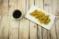 Fried Banana (Pisang Goreng), traditional snack in Malaysia with black coffee cup.