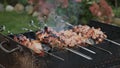 Fried barbecue kebab. Man cooking shish kebab grilling on skewers outside.