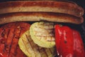 Fried barbecue sausages near to grilled vegetables