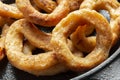 Fried battered onion rings in a cast iron frying pan.