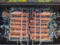 fried bbq sausages on the grill under hot coals top view Royalty Free Stock Photo