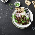 Fried beef minced bowl with basmati rice, purple onions, micro greens. Top View.