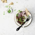 Fried beef minced bowl with basmati rice, purple onions, micro greens. Top View.