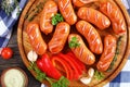 Fried beef sausages on round cutting board Royalty Free Stock Photo