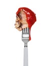 Fried beef steak poured with tomato ketchup on a fork close up isolated on a white background Royalty Free Stock Photo