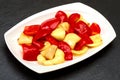 Fried bell pepper on a white plate and black background