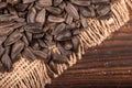 Fried black sunflower seeds scattered on the table, close-up, selective focus Royalty Free Stock Photo