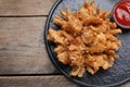 Fried blooming onion with dipping sauce served on wooden table, top view. Space for text Royalty Free Stock Photo