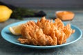 Fried blooming onion served on blue wooden table, closeup Royalty Free Stock Photo