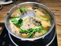 Fried Bonito Sea Bass and Taro in Clear Soup on Hot Pot.