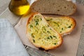 Fried bread with olive oil, garlic and herbs on a wooden table. Rustic style