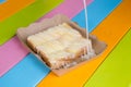 Toast topped with sweetened condensed milk in a paper dish on a wooden table. Royalty Free Stock Photo