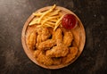 Fried in breaded chicken wings and french fries Royalty Free Stock Photo