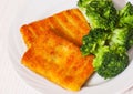 Fried breaded fish fillets with broccoli