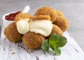 Fried breaded mozzarella cheese balls with tomato sauce close up Royalty Free Stock Photo