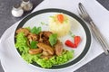 Fried bull testicles with cream and herbs served with mashed potato on a white plate on an abstract background. Healthy