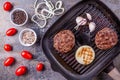 Fried burger beef cutlets with vegetables on grill pan on gray marble background Royalty Free Stock Photo