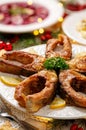 Fried carp fish slices on a white plate, close up. Traditional christmas eve dish. Royalty Free Stock Photo