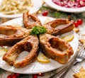 Fried carp fish slices on a white plate, close up. Traditional christmas eve dish. Royalty Free Stock Photo