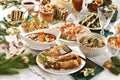 Fried carp, mushroom soup, sauerkraut and other dishes and pastries for traditional Polish Christmas Eve supper Royalty Free Stock Photo