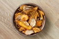 Fried carrot and parsnip chips in rustic wood bowl. From above. Royalty Free Stock Photo