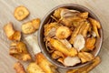 Fried carrot and parsnip chips in rustic wood bowl. From above. Royalty Free Stock Photo