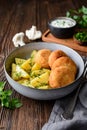 Fried cauliflower and cheese croquettes with boiled potatoes and sour cream dip