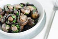 Fried champignons with garlic and parsley in a gray bowl. Vegetarian lifestyle concept. Royalty Free Stock Photo