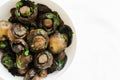 Fried champignons with garlic and parsley in a white bowl on the table. The concept of vegetarian food. Royalty Free Stock Photo