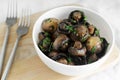 Fried champignons with garlic and parsley in a white bowl. Vegetarian lifestyle concept. Royalty Free Stock Photo